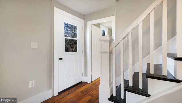 a view of staircase with wooden floor and chair