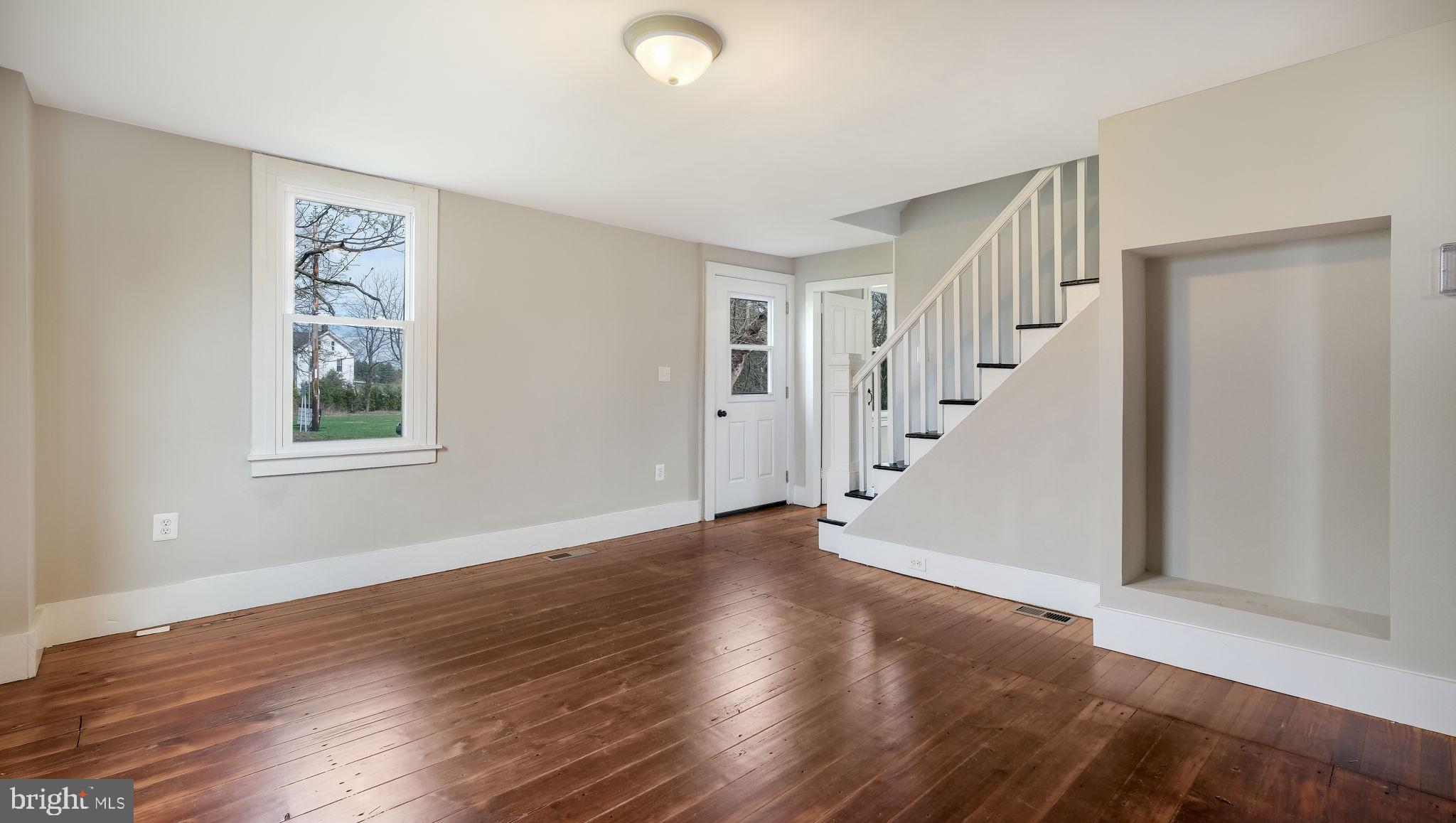5182 Point Pleasant Pike Doylestown, PA 18902 - Photo 6 of 35 a view of an empty room with wooden floor and stairs