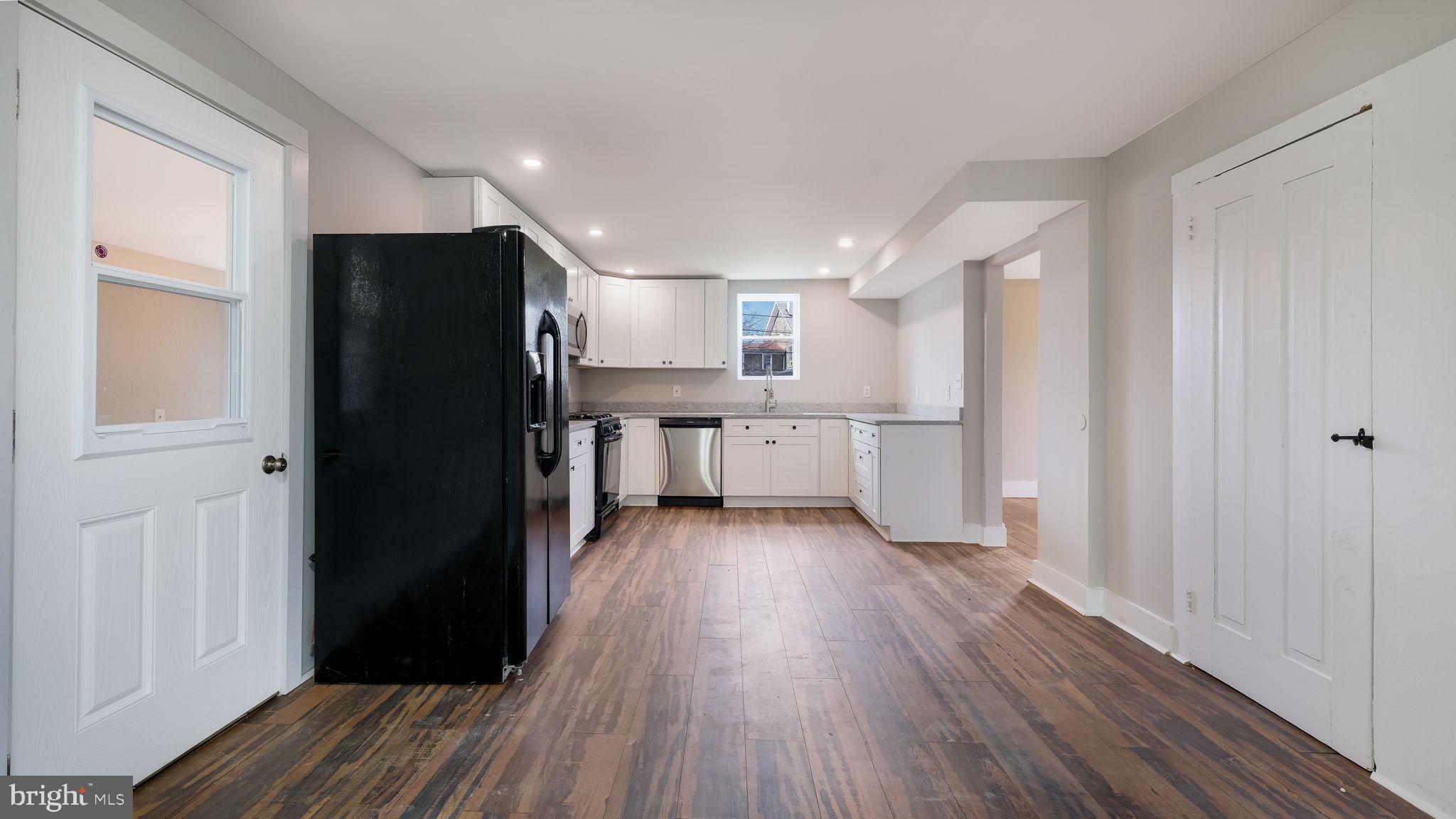 5182 Point Pleasant Pike Doylestown, PA 18902 - Photo 7 of 35 a view of a refrigerator in kitchen and wooden floor