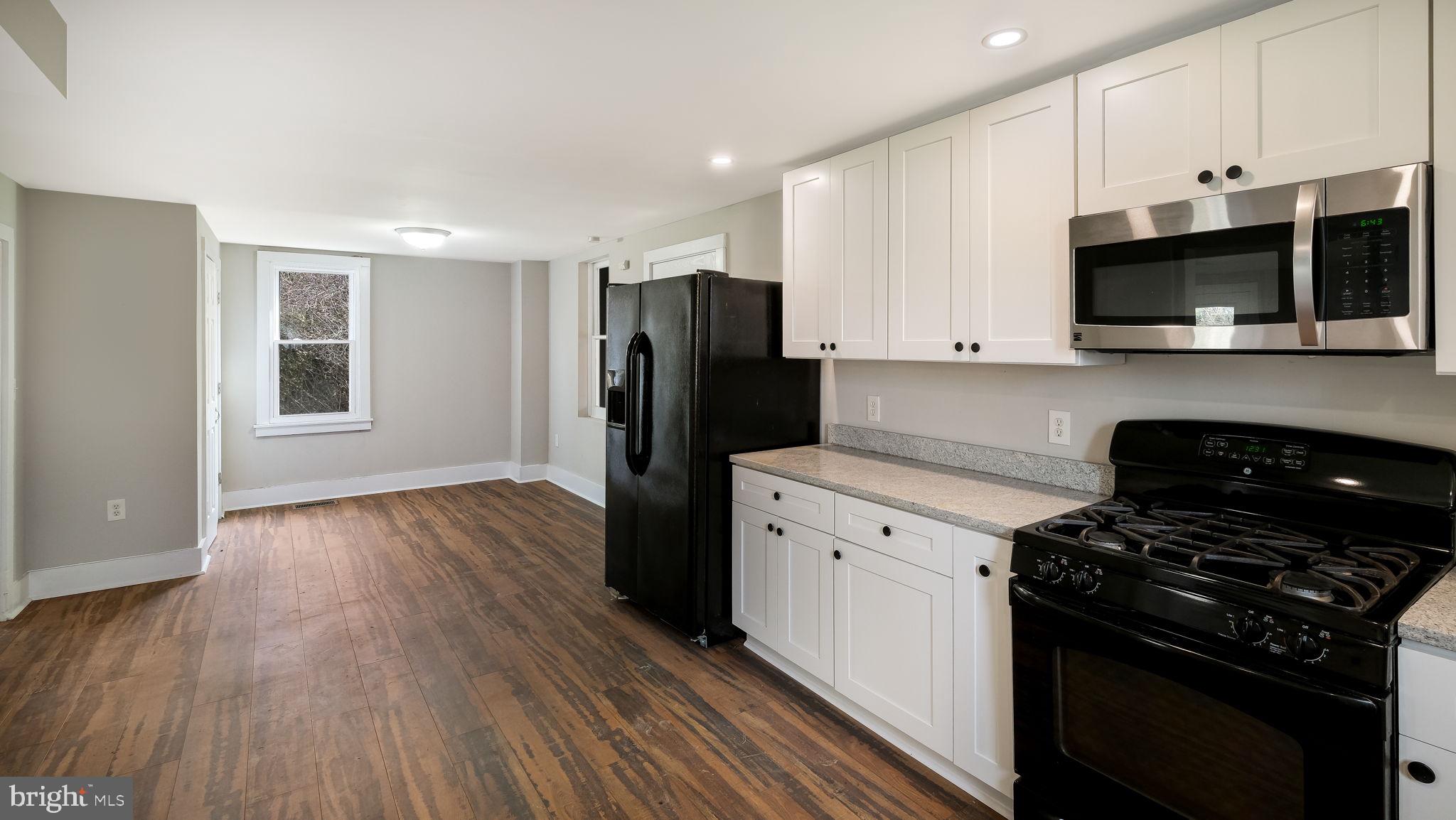5182 Point Pleasant Pike Doylestown, PA 18902 - Photo 10 of 35 a kitchen with stainless steel appliances a stove a microwave and cabinets