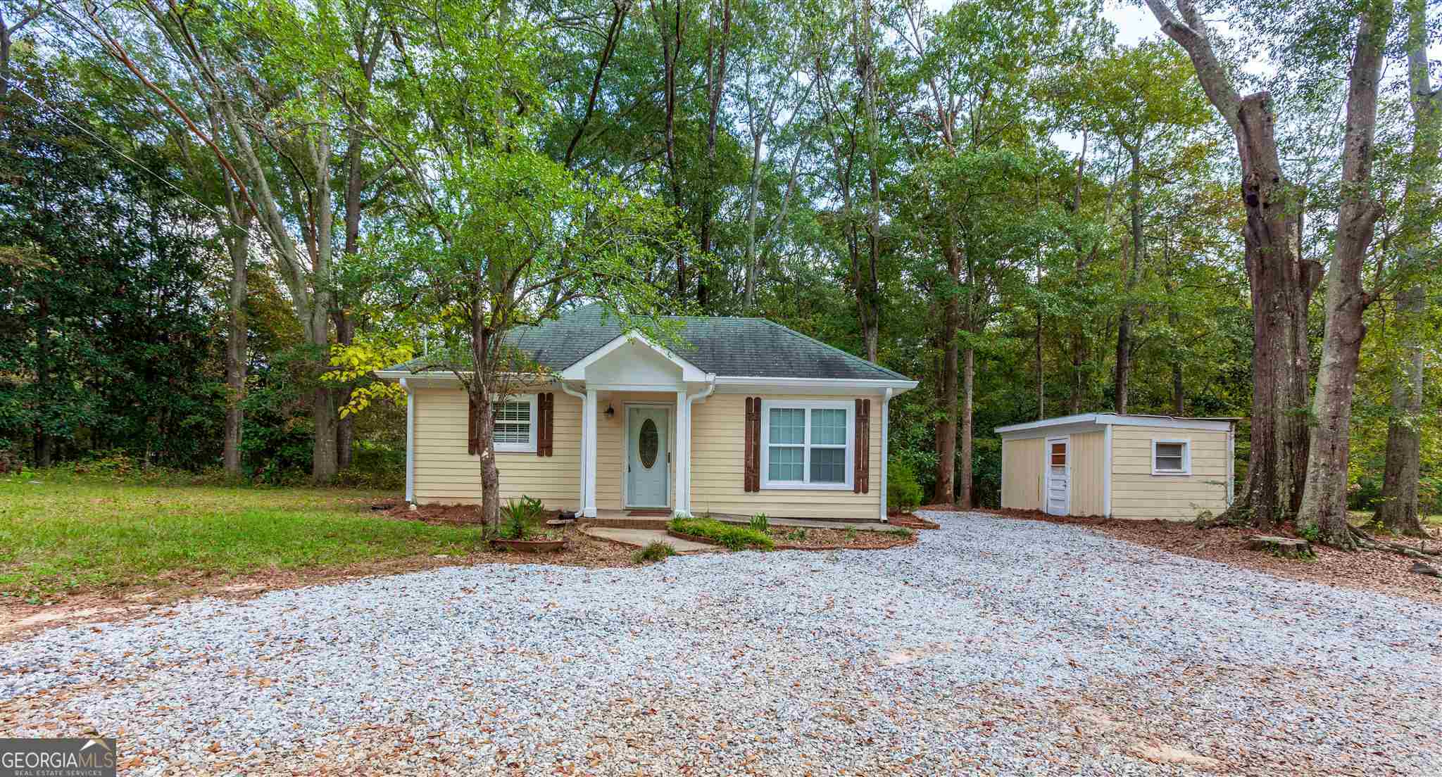 45 Bridge Street Senoia, GA 30276 - Photo 2 of 19 a front view of a house with a yard and trees
