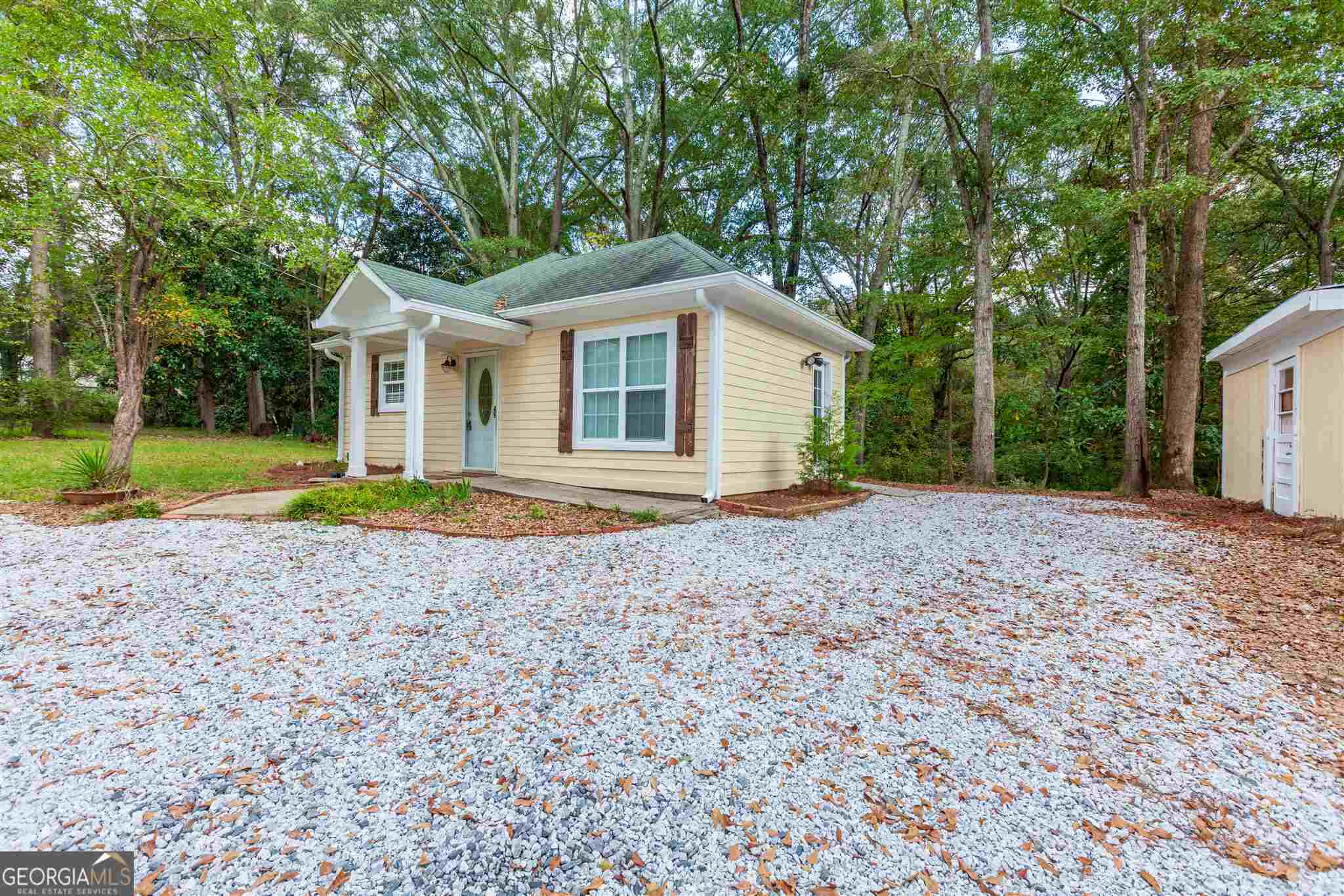 45 Bridge Street Senoia, GA 30276 - Photo 3 of 19 a front view of a house with a yard and trees