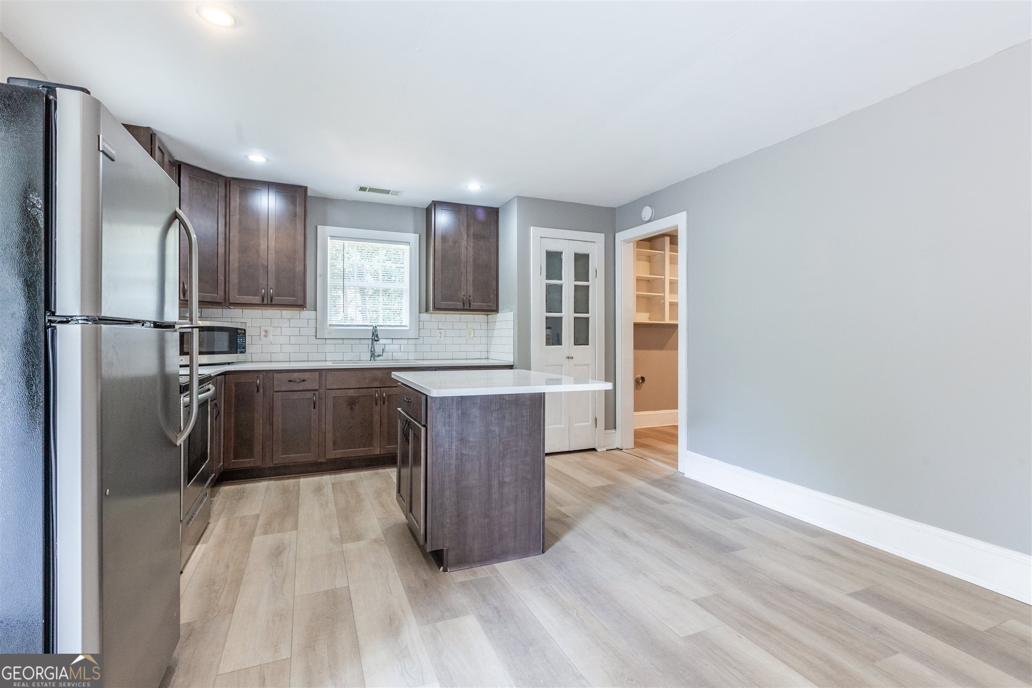 45 Bridge Street Senoia, GA 30276 - Photo 5 of 19 a kitchen with granite countertop a refrigerator and a sink
