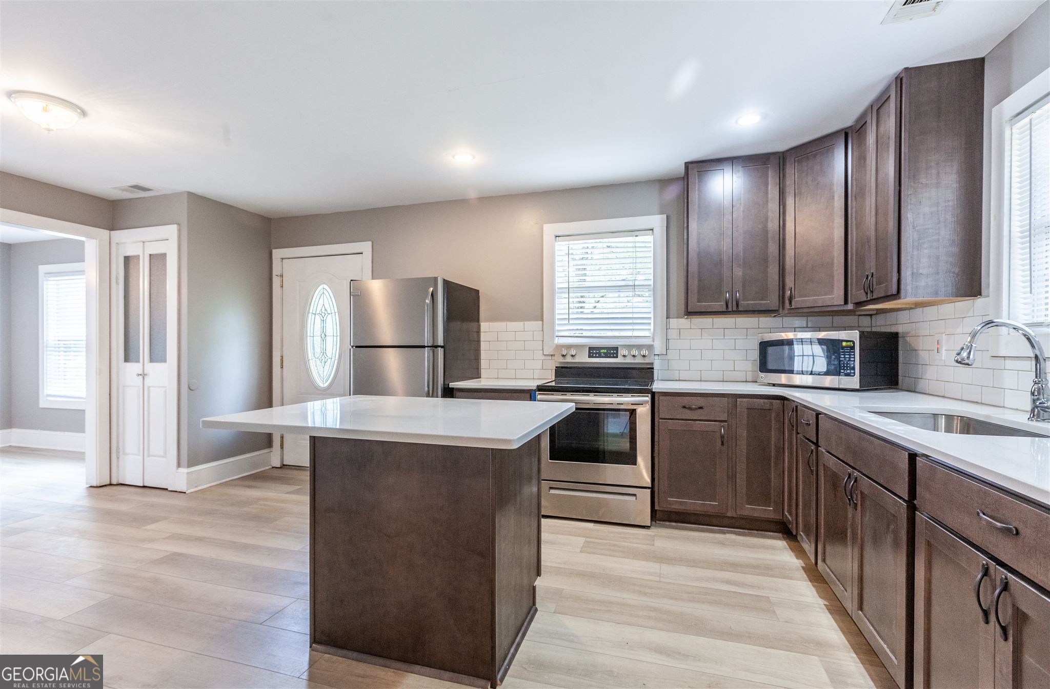 45 Bridge Street Senoia, GA 30276 - Photo 7 of 19 a kitchen with stainless steel appliances granite countertop a refrigerator sink and cabinets