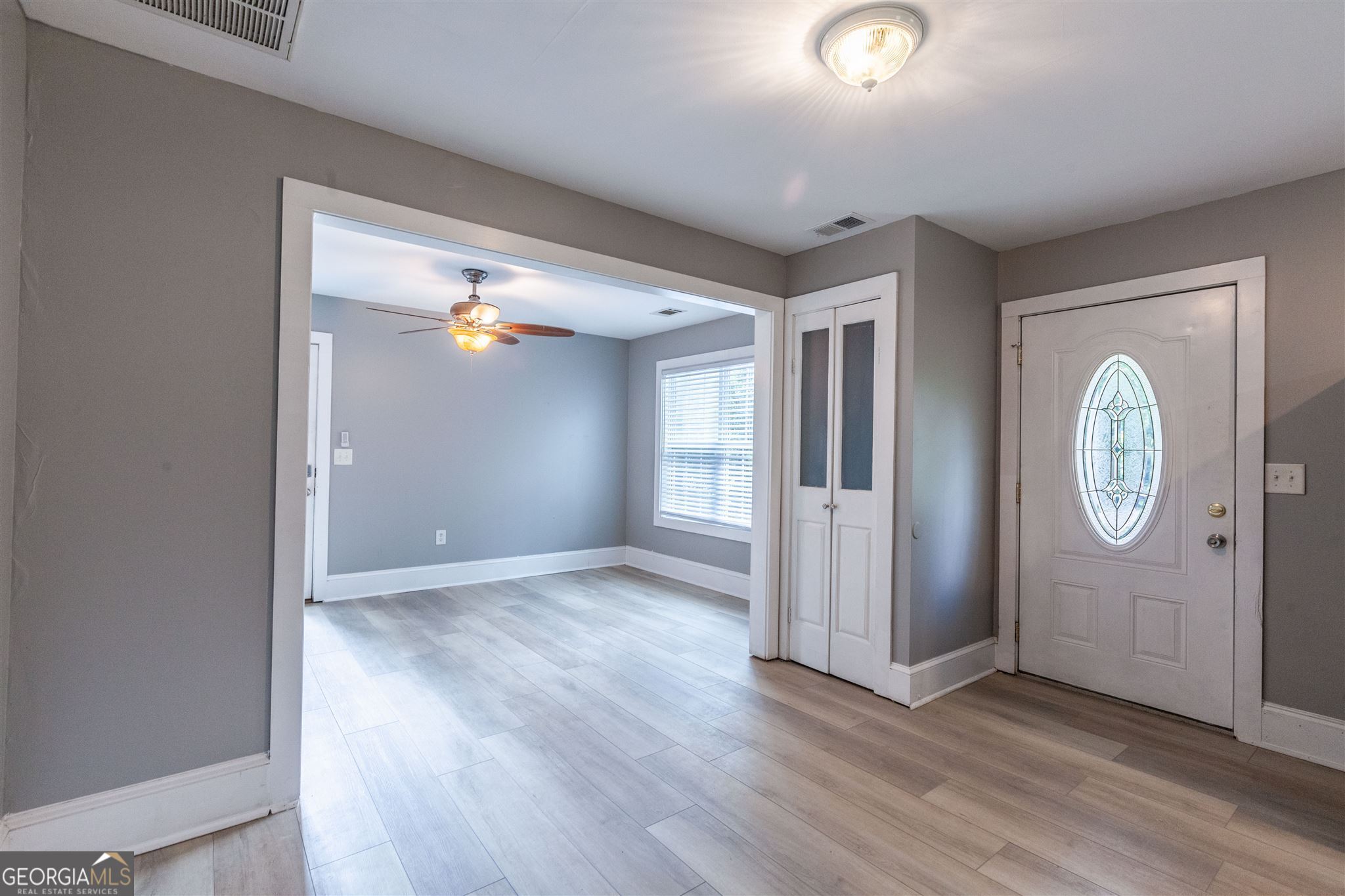 45 Bridge Street Senoia, GA 30276 - Photo 9 of 19 an empty room with wooden floor and mirror
