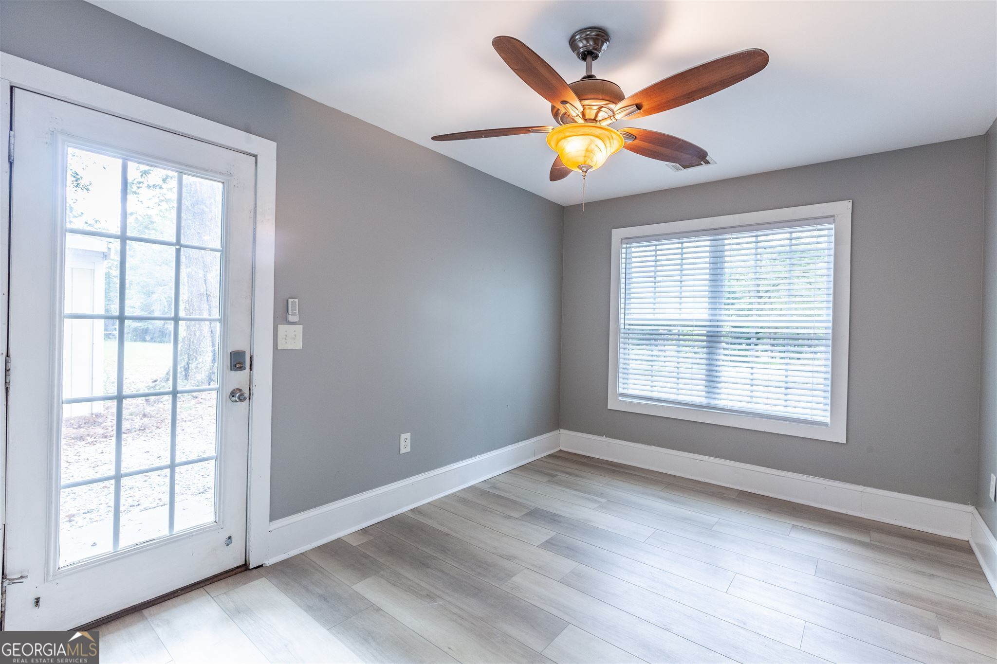 45 Bridge Street Senoia, GA 30276 - Photo 10 of 19 a view of an empty room with wooden floor and a window