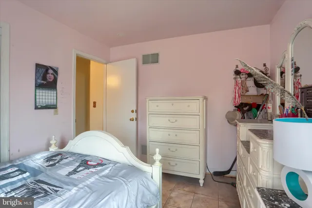 a bedroom with a bed and a dresser in it