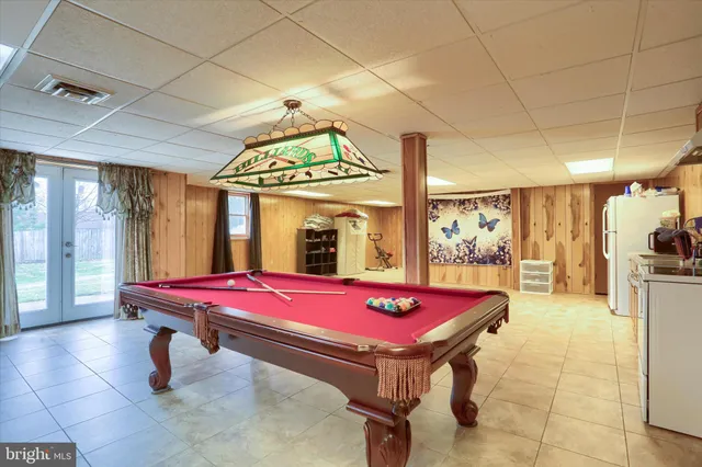 a bathroom with a bathtub shower sink and mirror