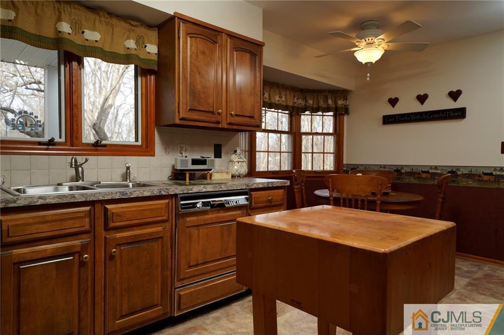 203 Crosswicks Ellisdale Road Chesterfield, NJ 08515 - Photo 15 of 25 a kitchen with stainless steel appliances granite countertop a sink dishwasher stove and refrigerator with wooden floor