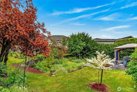 a backyard of a house with table and chairs
