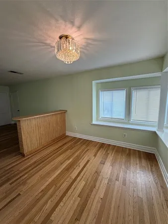 a view of a room with wooden floor and stairs