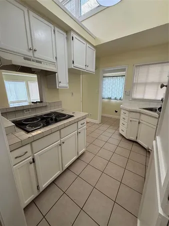 a bathroom with a sink a window and a mirror
