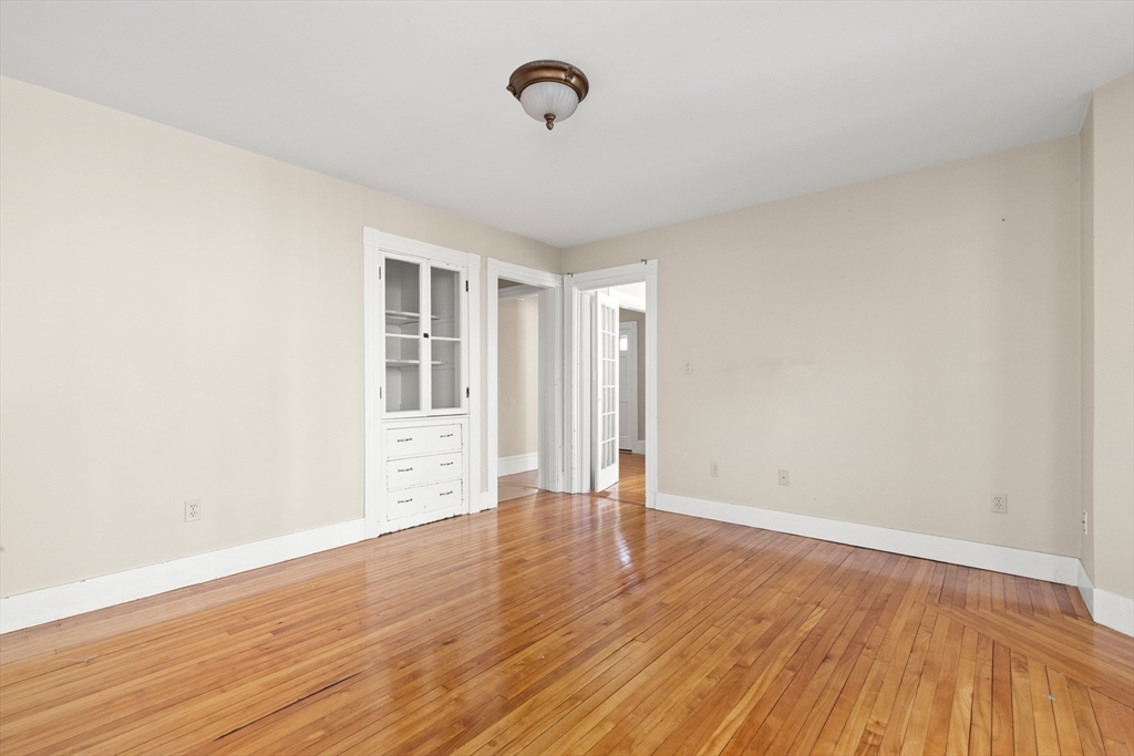 23 Proctor Street Salem, MA 01970 - Photo 11 of 41 a view of an empty room with wooden floor and a window