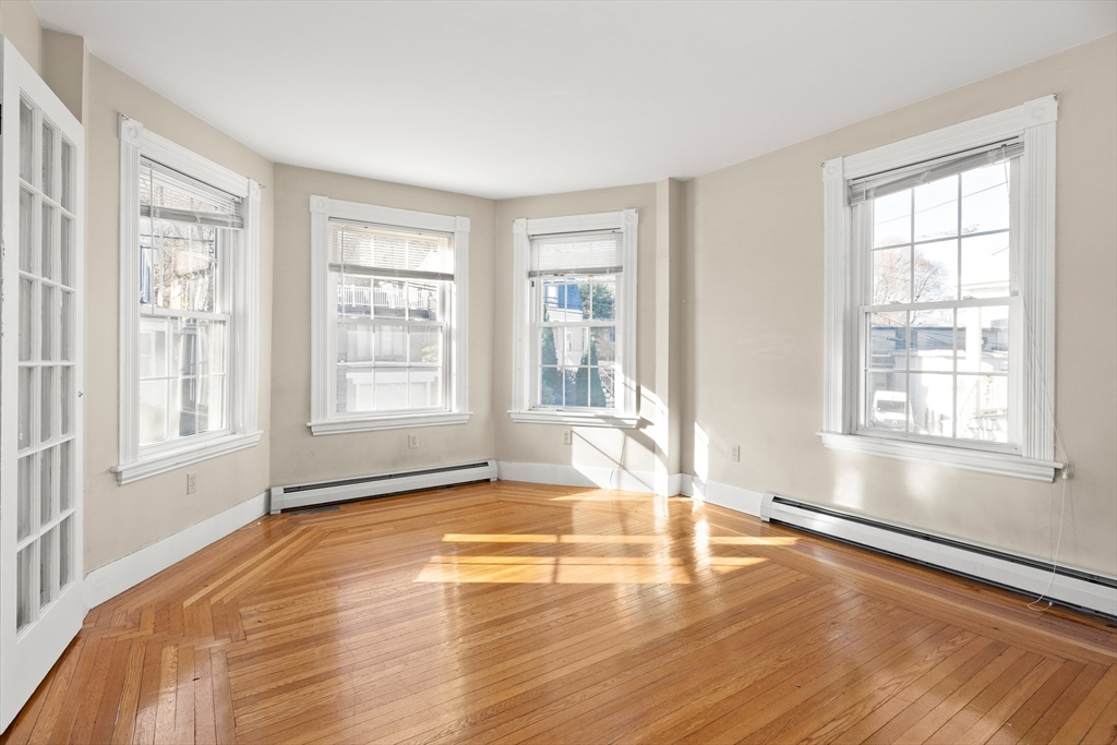 23 Proctor Street Salem, MA 01970 - Photo 12 of 41 a view of empty room with wooden floor and fan