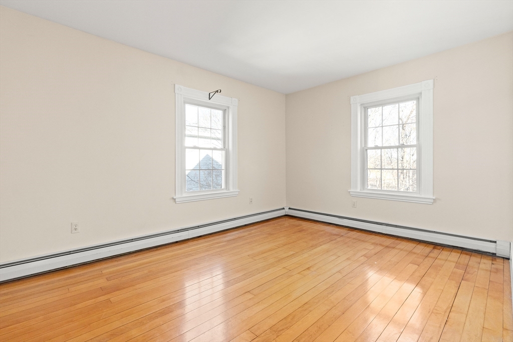 23 Proctor Street Salem, MA 01970 - Photo 22 of 41 wooden floor in an empty room with a window