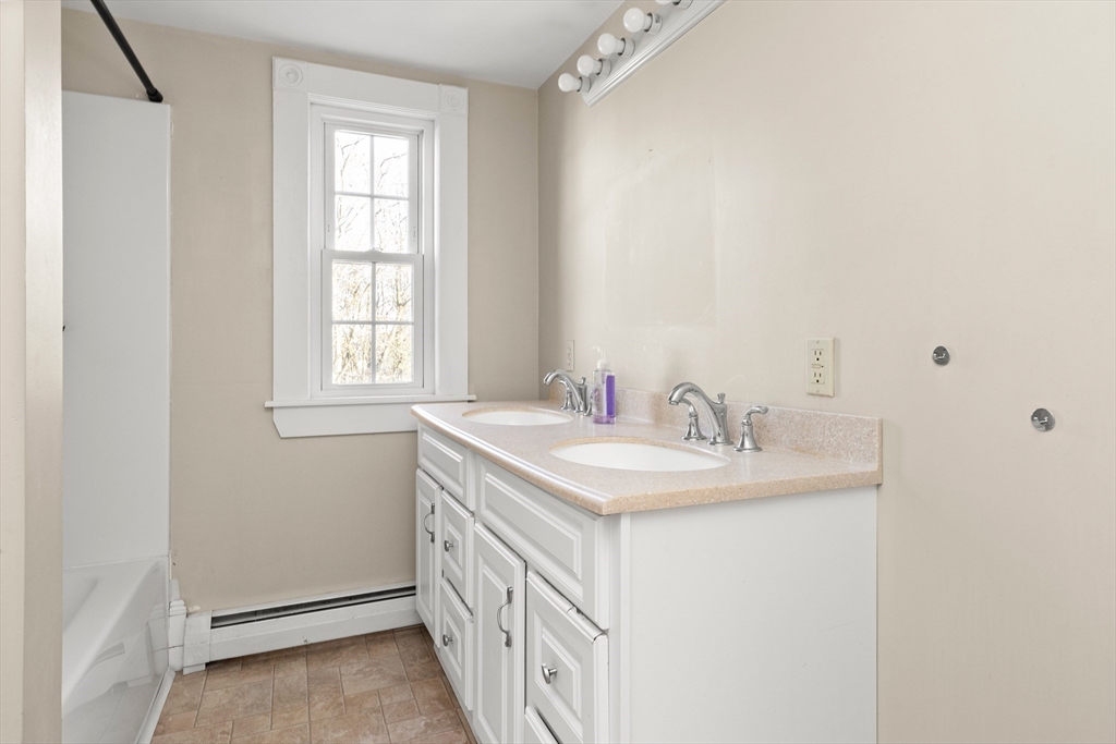 23 Proctor Street Salem, MA 01970 - Photo 24 of 41 a bathroom with a sink and a mirror