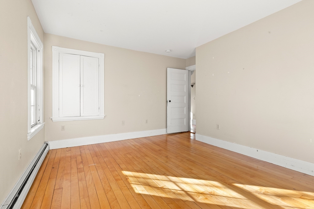 23 Proctor Street Salem, MA 01970 - Photo 26 of 41 a view of empty room with wooden floor and fan