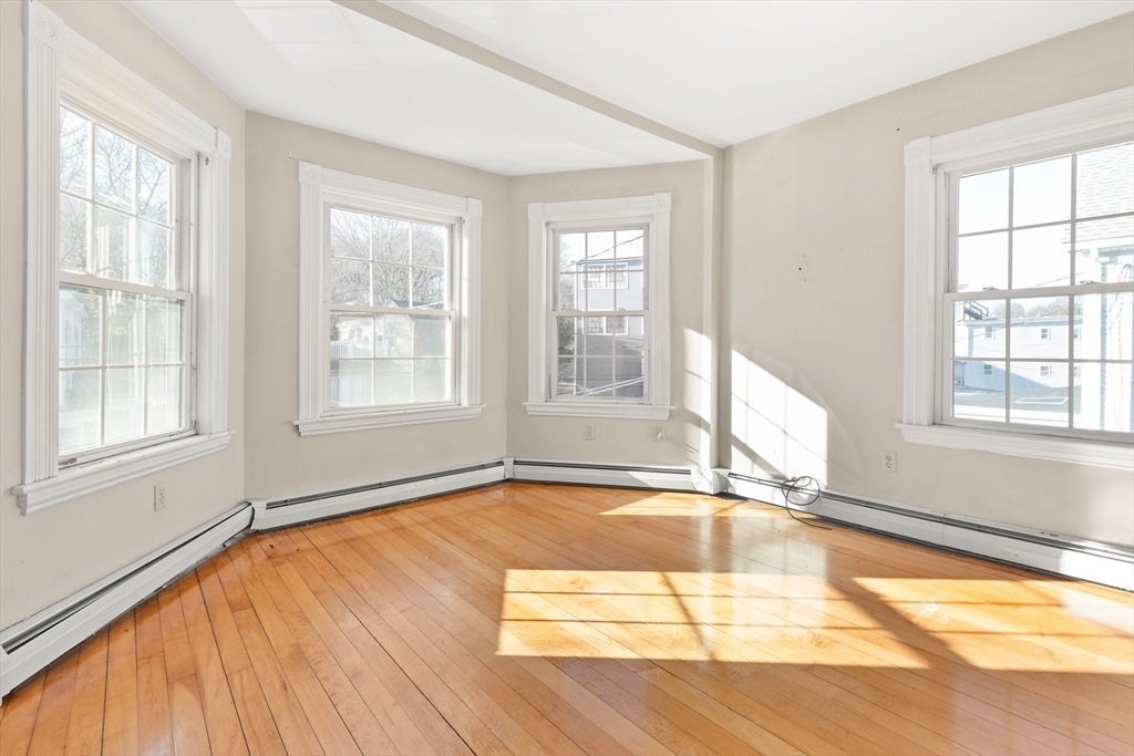 23 Proctor Street Salem, MA 01970 - Photo 27 of 41 a view of an empty room with wooden floor and a window