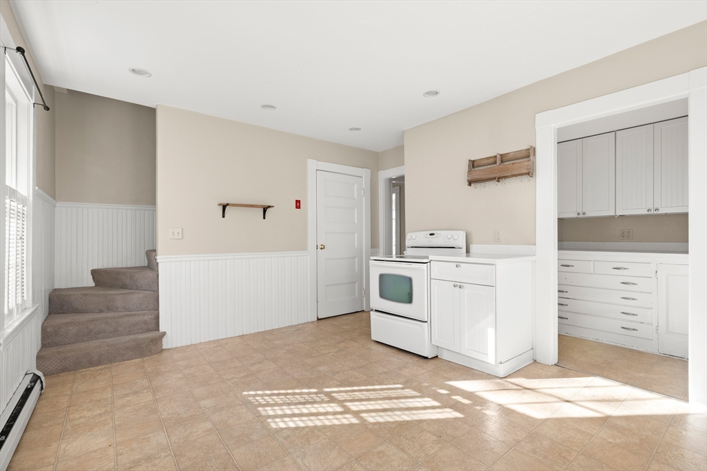 23 Proctor Street Salem, MA 01970 - Photo 6 of 41 a view of a kitchen with white cabinets and white appliances