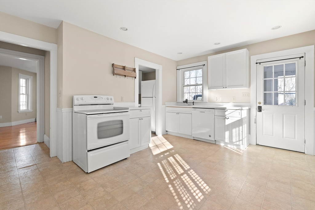 23 Proctor Street Salem, MA 01970 - Photo 7 of 41 a kitchen with white cabinets and white appliances