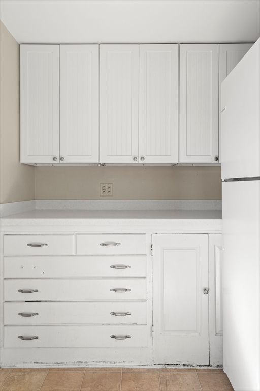 23 Proctor Street Salem, MA 01970 - Photo 8 of 41 a view of white cabinets and a white refrigerator