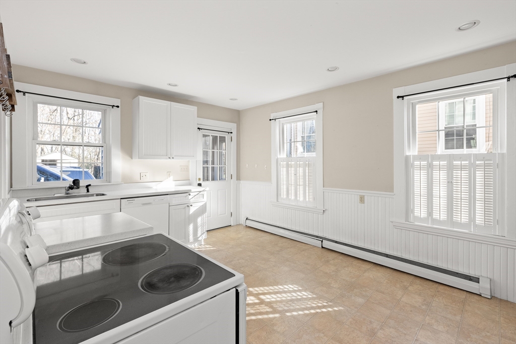 23 Proctor Street Salem, MA 01970 - Photo 9 of 41 a kitchen that has a sink and a stove in it