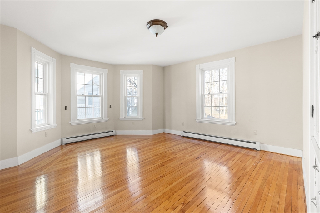 23 Proctor Street Salem, MA 01970 - Photo 10 of 41 an empty room with wooden floor and windows