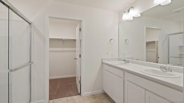 a bathroom with a double vanity sink and a mirror