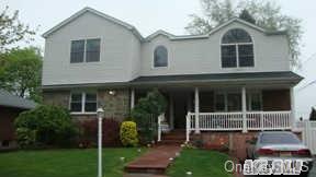 102 Seaman Road Jericho, NY 11753 - Photo 1 of 1 a front view of a house with a yard