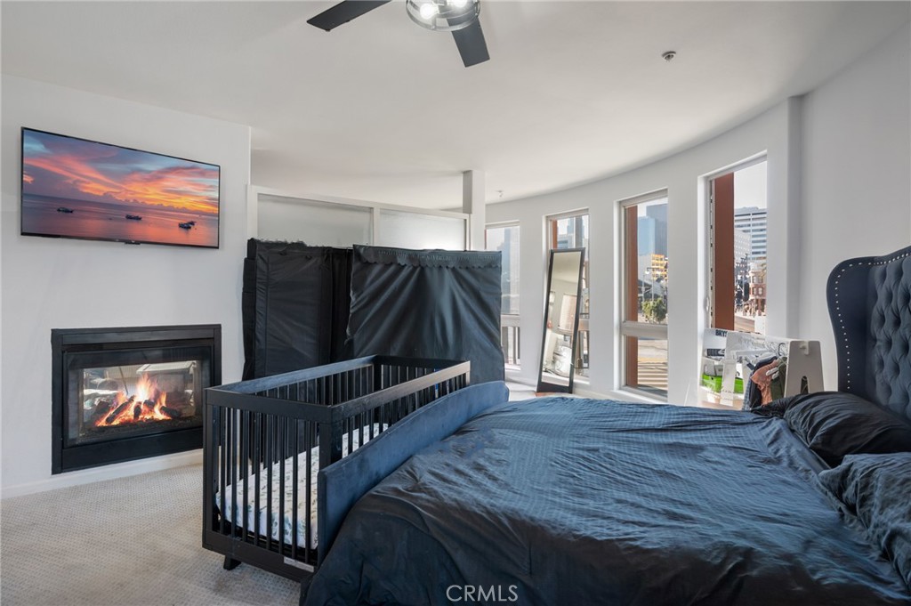 100 South Alameda Street, Unit 210 Los Angeles, CA 90012 - Photo 12 of 16 a bedroom with furniture and a fireplace