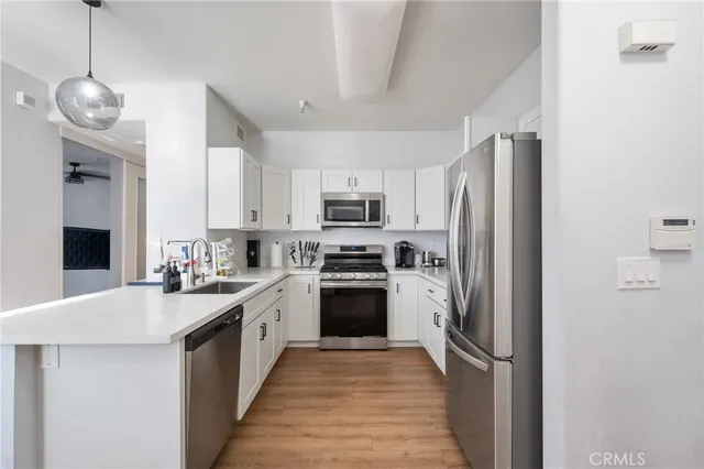 a kitchen with a sink and stainless steel appliances