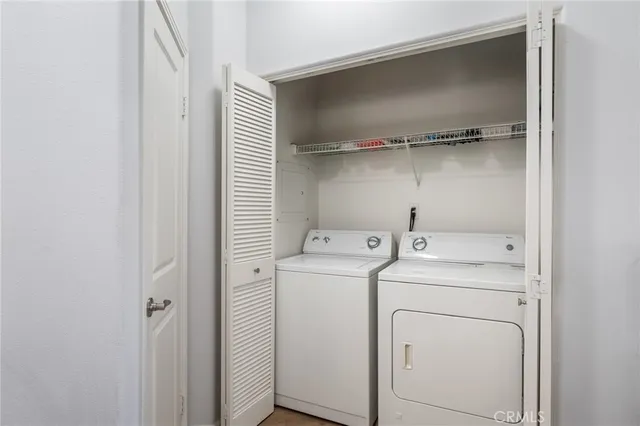 a view of storage and utility room with washer and dryer