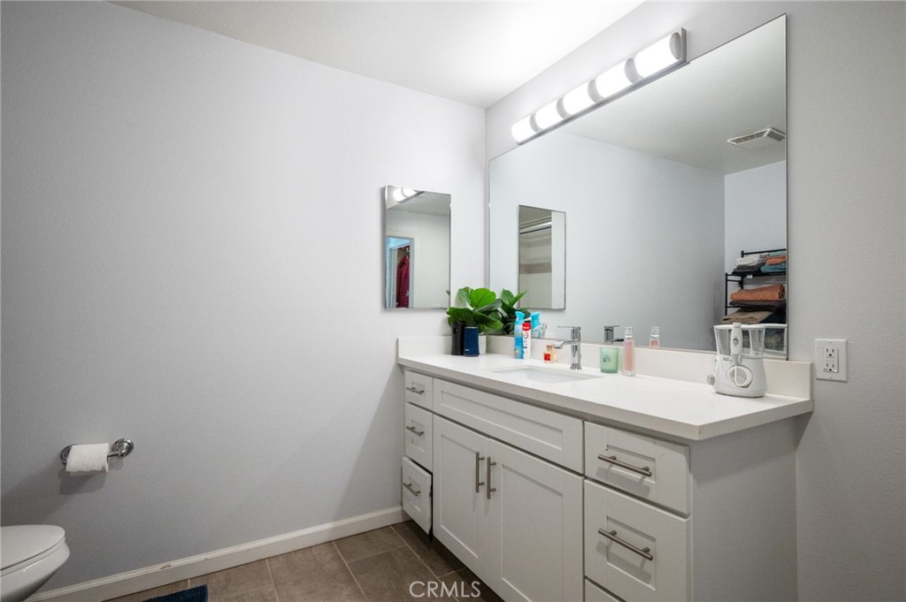 100 South Alameda Street, Unit 210 Los Angeles, CA 90012 - Photo 10 of 16 a bathroom with a sink and a mirror