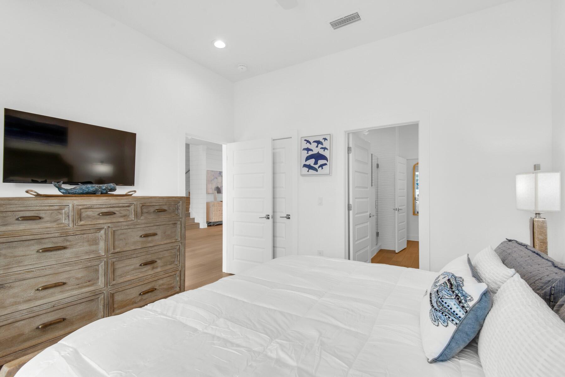 65 Cobia Street Destin, FL 32541 - Photo 17 of 54 a bedroom with a bed and a flat screen tv