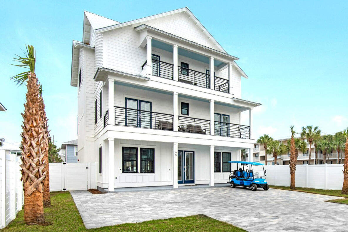 65 Cobia Street Destin, FL 32541 - Photo 2 of 54 a front view of a building with a yard