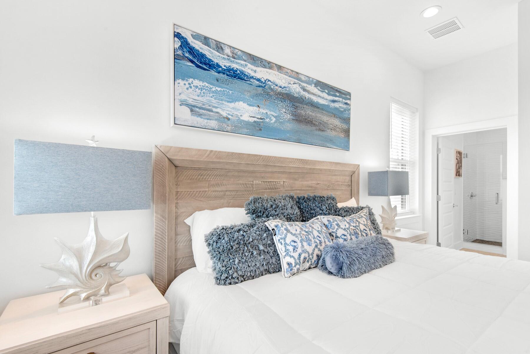 65 Cobia Street Destin, FL 32541 - Photo 21 of 54 a bedroom with a bed and a painting on the wall