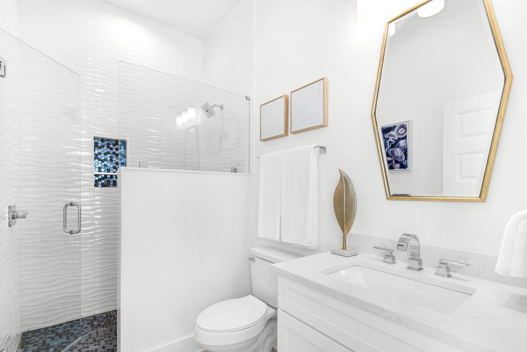 65 Cobia Street Destin, FL 32541 - Photo 22 of 54 a bathroom with a sink vanity mirror and toilet