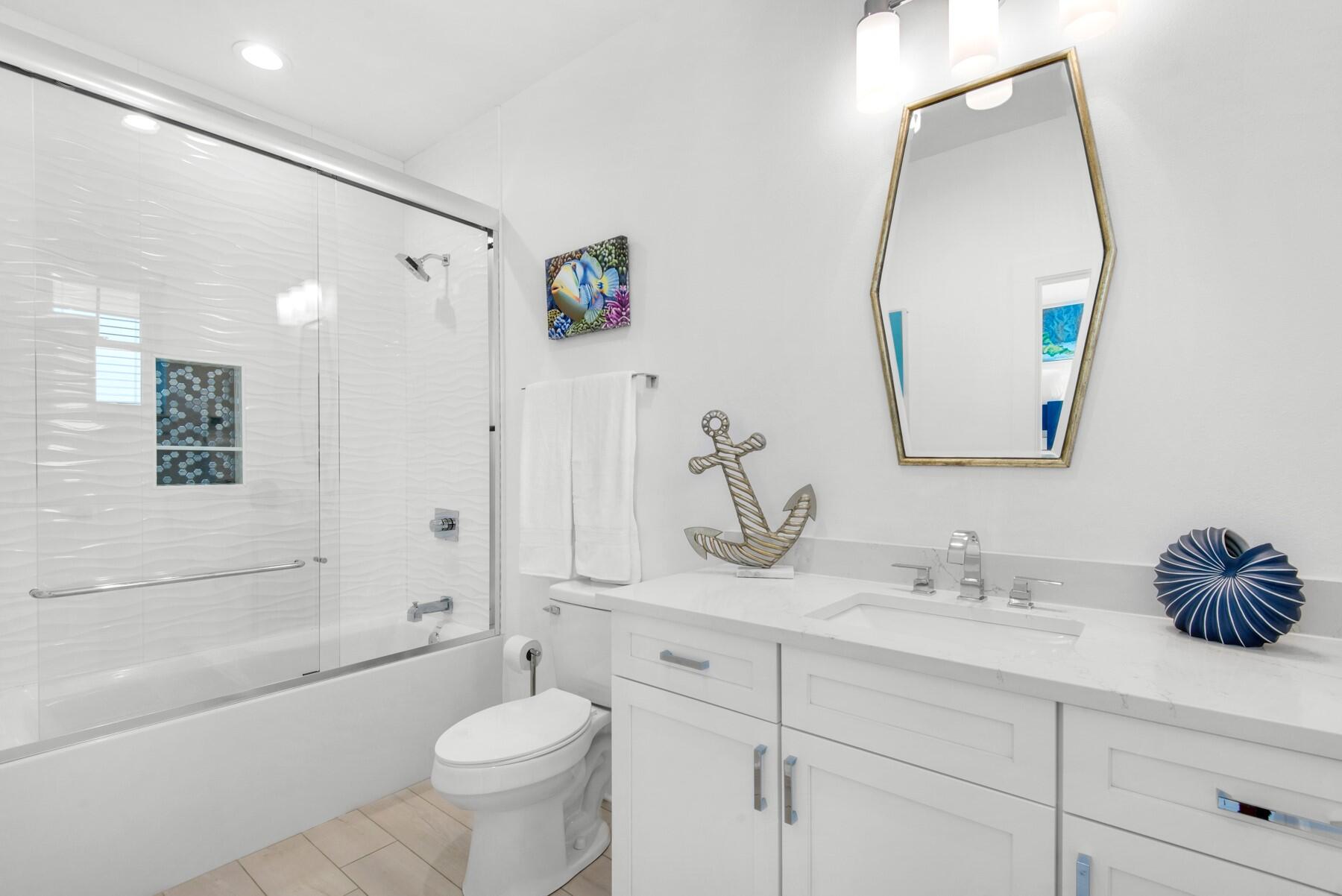 65 Cobia Street Destin, FL 32541 - Photo 27 of 54 a bathroom with a toilet sink and mirror
