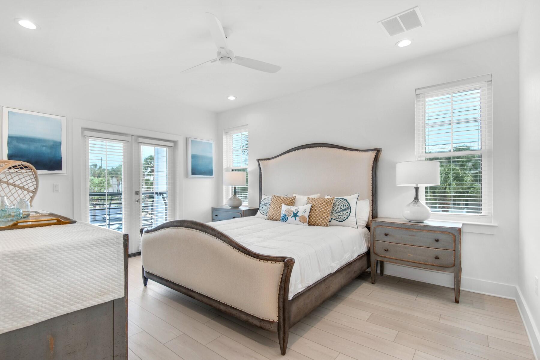 65 Cobia Street Destin, FL 32541 - Photo 28 of 54 a bedroom with a bed lamp and a window
