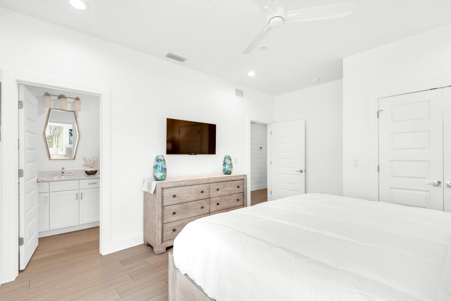 65 Cobia Street Destin, FL 32541 - Photo 37 of 54 a bedroom with a bed and a flat screen tv in it