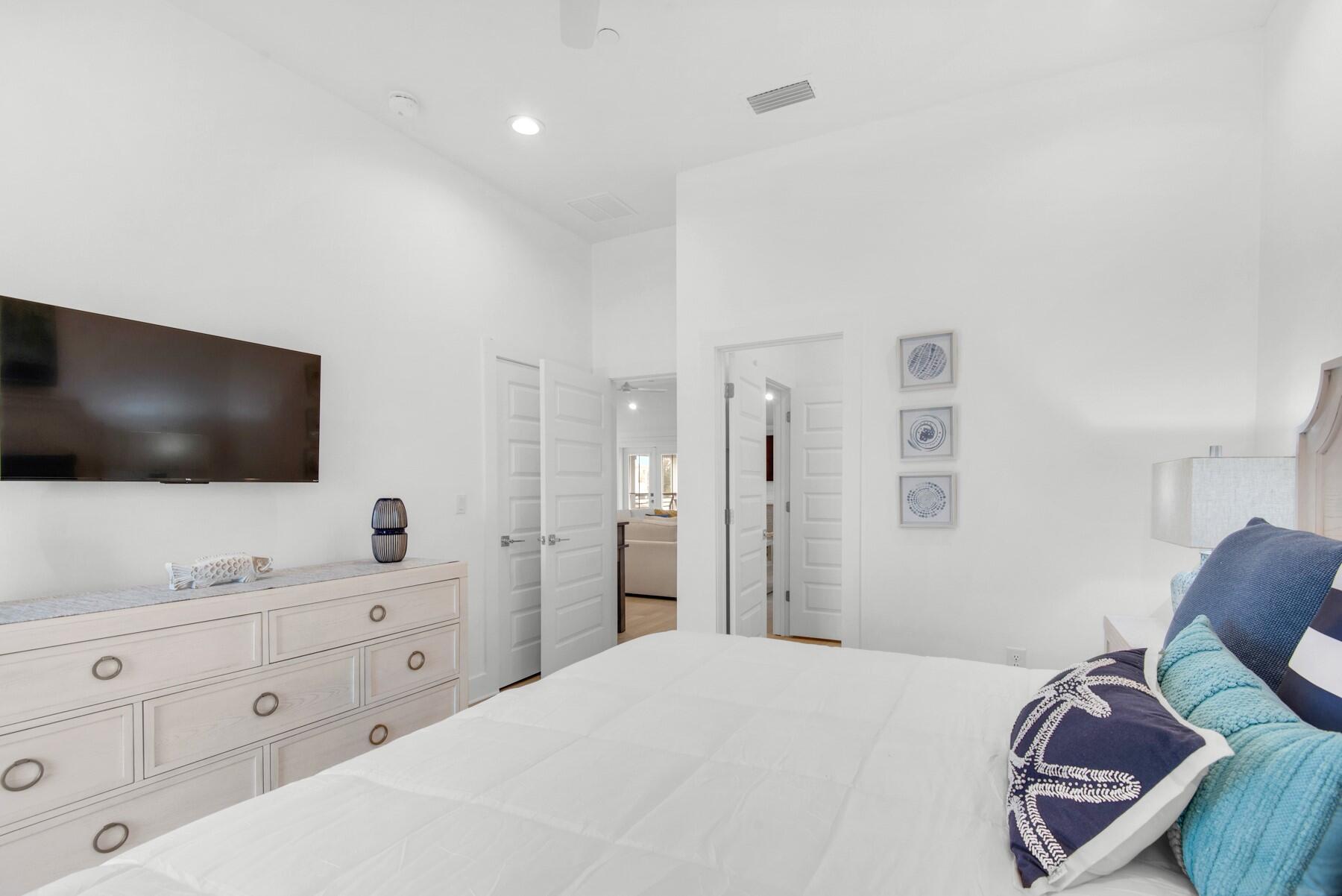 65 Cobia Street Destin, FL 32541 - Photo 43 of 54 a bedroom with a bed and a flat screen tv