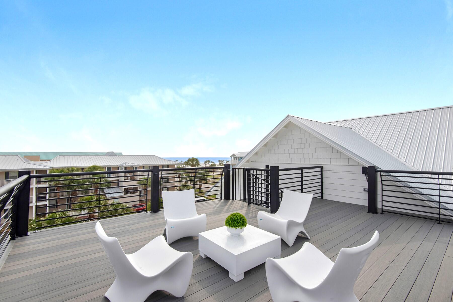65 Cobia Street Destin, FL 32541 - Photo 52 of 54 a roof deck with a table and chairs