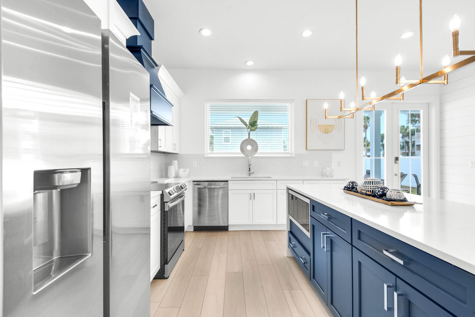 65 Cobia Street Destin, FL 32541 - Photo 6 of 54 a kitchen with a sink stainless steel appliances and cabinets