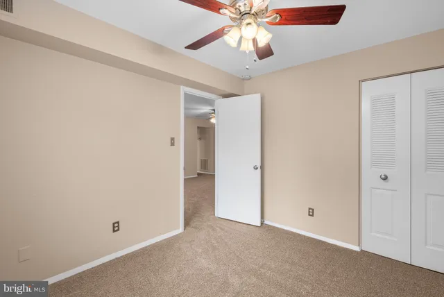 an empty room with a fan and a fan