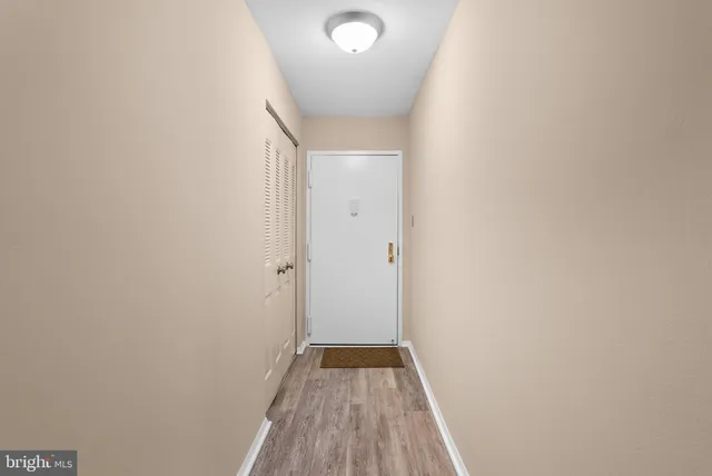 a view of hallway with wooden floor