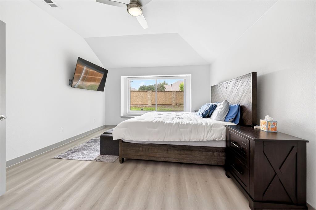 7503 Vista Ridge Lane Sachse, TX 75048 - Photo 17 of 33 This room features light-colored flooring, a window providing natural light, and a ceiling fan