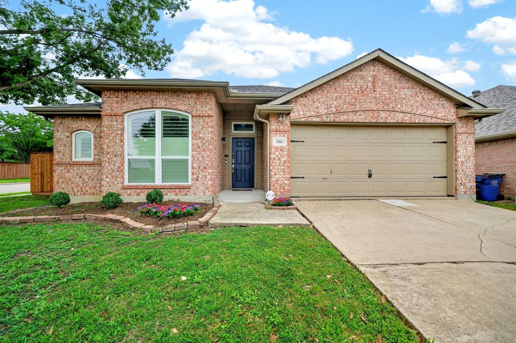 7503 Vista Ridge Lane Sachse, TX 75048 - Photo 2 of 33 This property features a brick exterior, a well-maintained lawn, and a concrete driveway leading to an attached garage