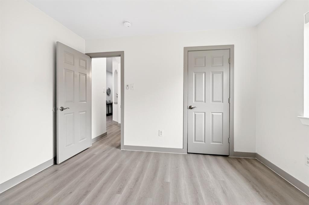 7503 Vista Ridge Lane Sachse, TX 75048 - Photo 24 of 33 This room features light-colored walls, grey trim, and wood-look flooring