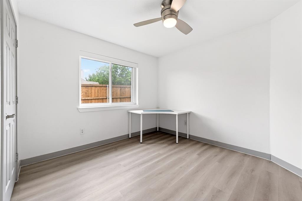 7503 Vista Ridge Lane Sachse, TX 75048 - Photo 25 of 33 This room features light-colored walls, wood-look flooring, and a ceiling fan with integrated lighting