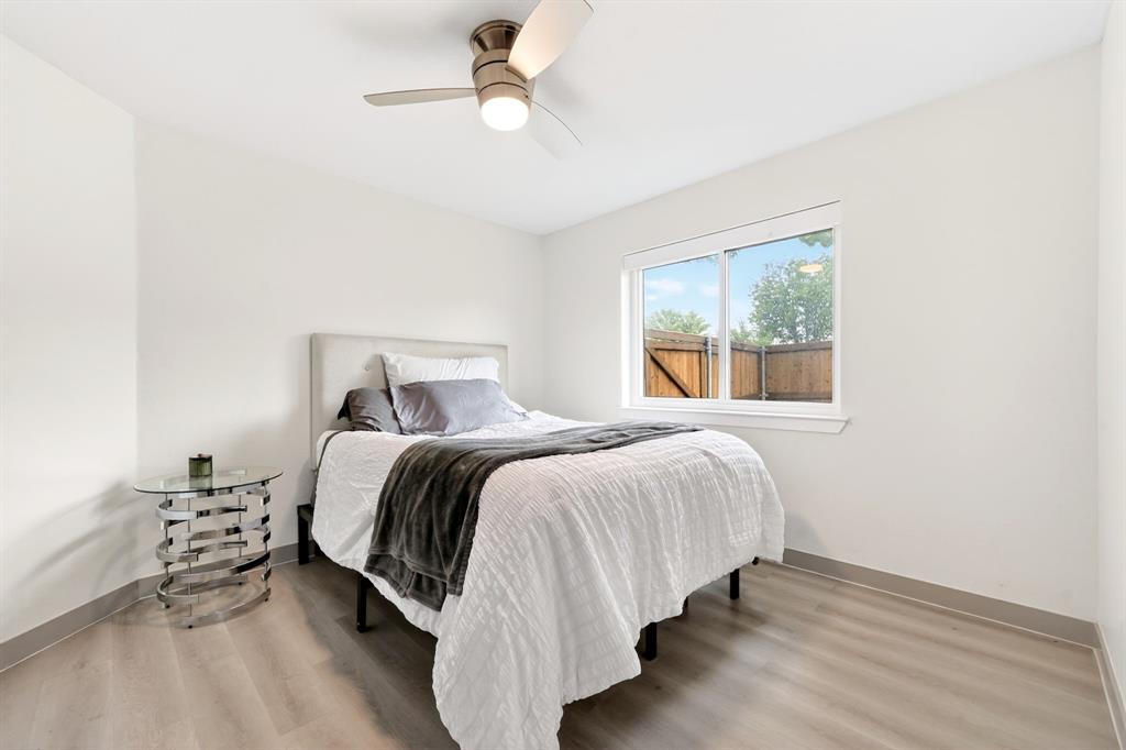 7503 Vista Ridge Lane Sachse, TX 75048 - Photo 27 of 33 The room features light-toned flooring, a window providing natural light, and a ceiling fan with integrated lighting